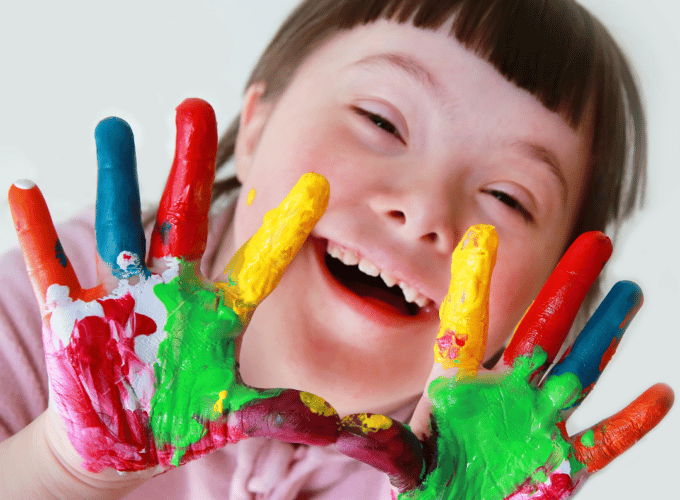 Smiling girl with paint on hands