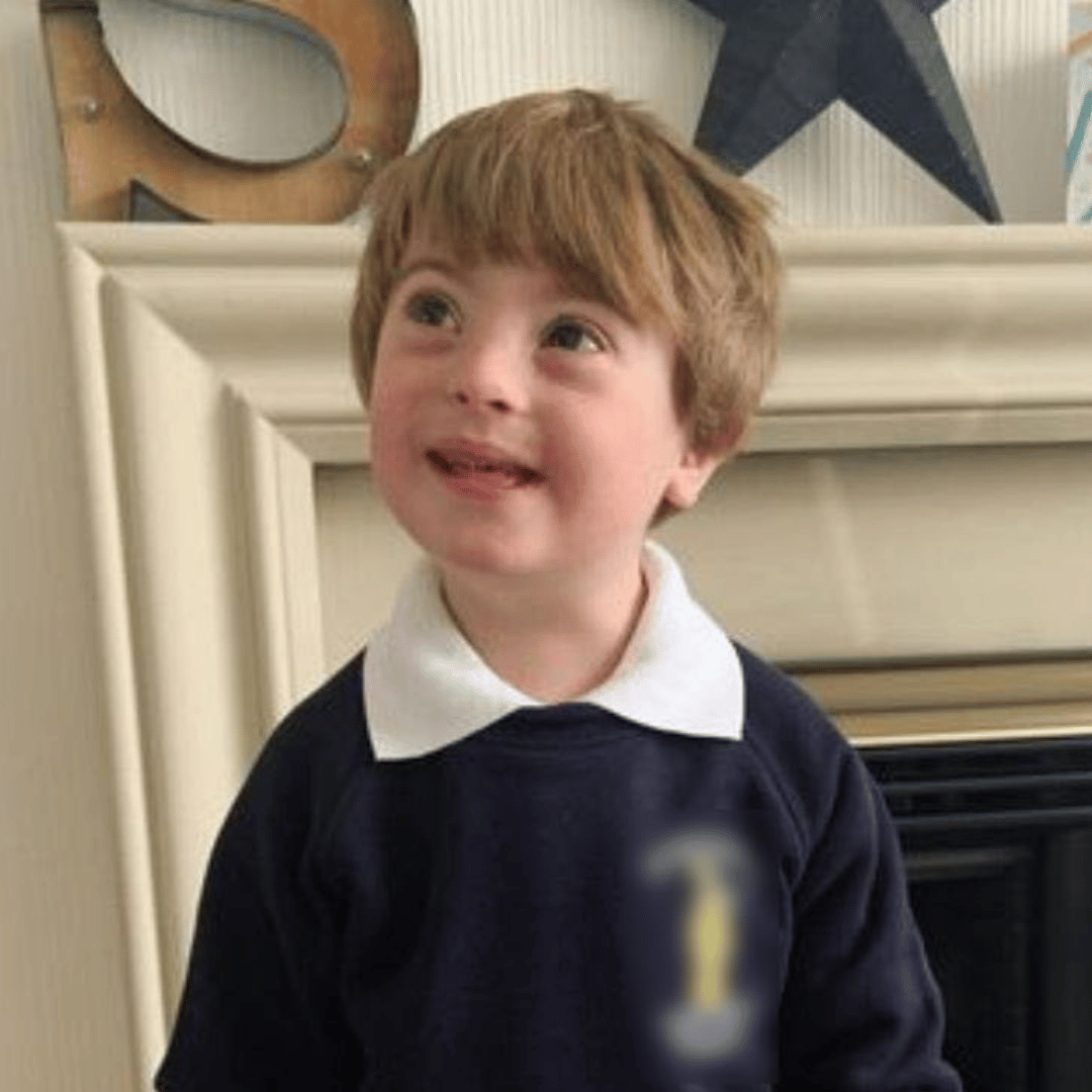 Boy with Down Syndrome in school uniform 