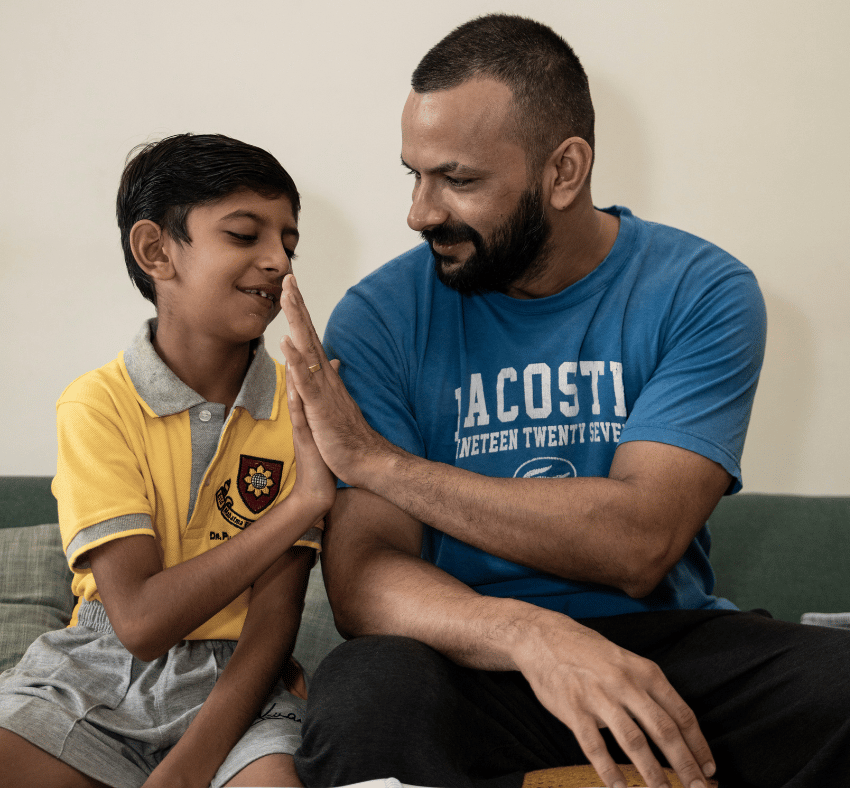 Boy with father high-fiving