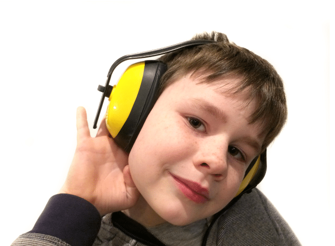 Boy wearing ear defernders