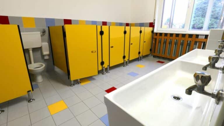 Row of toilet cubicles with yellow doors