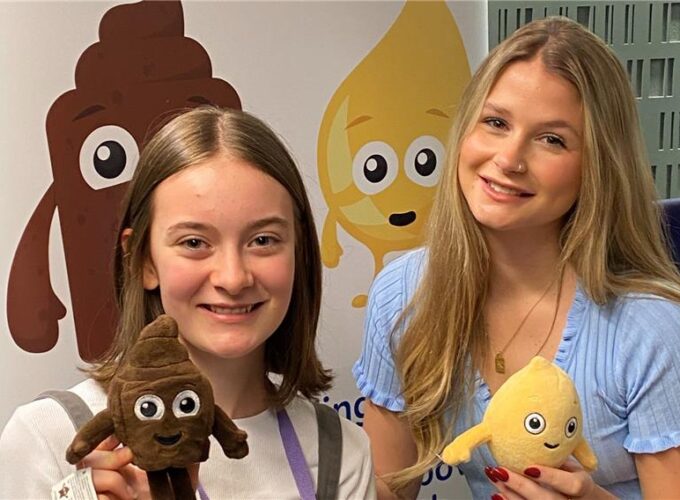 Eva (left) and Mollie Pearce (right) smiling and holding ERIC mascots Poo and Wee