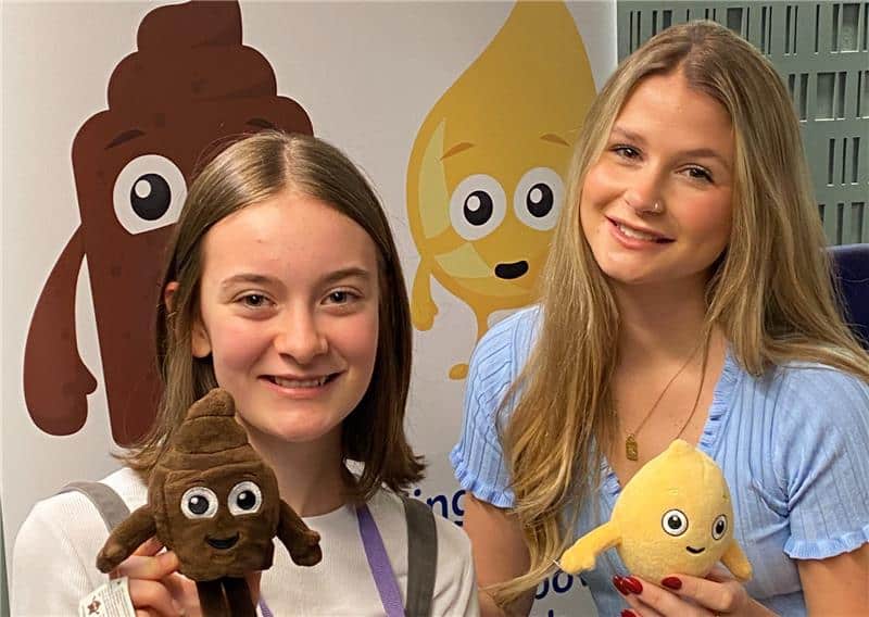 Eva (left) and Mollie Pearce (right) smiling and holding ERIC mascots Poo and Wee