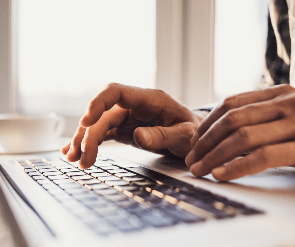 Hands typing on a keyboard