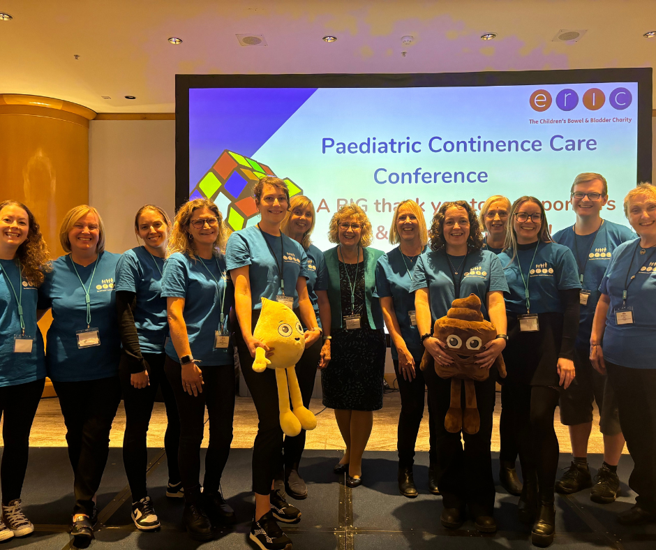 ERIC team standing in front of a sign that says ERIC Conference
